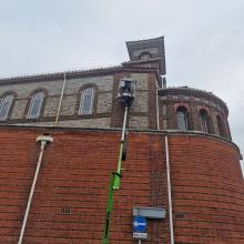 Using a Cherry Picker to clean a building